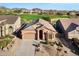 Aerial view of a single story home with a golf course in the background at 3517 N Paseo Del Sol --, Mesa, AZ 85207