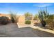Landscaped backyard with desert plants, gravel, a small concrete patio and privacy wall at 3517 N Paseo Del Sol --, Mesa, AZ 85207