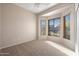 Bright bedroom with a ceiling fan, carpet flooring, and large windows for natural light at 3517 N Paseo Del Sol --, Mesa, AZ 85207