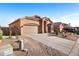 Single story home featuring a two car garage, driveway, and desert landscaping at 3517 N Paseo Del Sol --, Mesa, AZ 85207