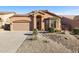 Single story home featuring a two car garage and desert landscaping at 3517 N Paseo Del Sol --, Mesa, AZ 85207