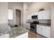 Kitchen with stainless steel appliances, granite countertops, and bright white cabinetry at 3517 N Paseo Del Sol --, Mesa, AZ 85207