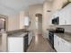 Gourmet kitchen featuring a breakfast bar, stainless appliances, granite counters, and stylish white cabinetry at 3517 N Paseo Del Sol --, Mesa, AZ 85207