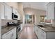 Bright kitchen with granite counters, stainless appliances, an eat-in area, and ample storage space at 3517 N Paseo Del Sol --, Mesa, AZ 85207