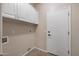 Well-lit laundry room with overhead cabinets and hookups for washer and dryer at 3517 N Paseo Del Sol --, Mesa, AZ 85207