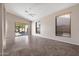 Open-concept living room featuring tile flooring, high ceilings, and access to the backyard at 3517 N Paseo Del Sol --, Mesa, AZ 85207