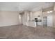 Open-concept living room showcasing tile floors, modern lighting, and a glimpse of the updated kitchen at 3517 N Paseo Del Sol --, Mesa, AZ 85207