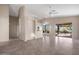 Spacious living room with tile flooring, a ceiling fan, and sliding glass doors leading to the backyard at 3517 N Paseo Del Sol --, Mesa, AZ 85207
