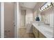 Well-lit main bathroom with dual sinks, walk-in shower, and a separate toilet room at 3517 N Paseo Del Sol --, Mesa, AZ 85207
