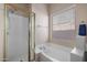 Elegant bathroom with a soaking tub, glass enclosed shower, and a large window at 3517 N Paseo Del Sol --, Mesa, AZ 85207