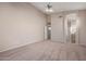 Spacious main bedroom boasting high ceilings, neutral carpet, a ceiling fan, and an attached bathroom at 3517 N Paseo Del Sol --, Mesa, AZ 85207