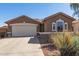 Attractive single-story home featuring desert landscaping, a driveway, and an attached two-car garage at 35487 N Shorthorn Trl, San Tan Valley, AZ 85143