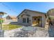 Backyard view featuring a covered patio, outdoor seating, and a well-manicured lawn, ideal for leisure and entertainment at 3780 E Waterman St, Gilbert, AZ 85297