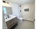 Bathroom featuring a glass shower with white tile and modern sink at 3807 N 64Th Dr, Phoenix, AZ 85033
