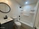 Modern bathroom featuring elegant fixtures, a stylish vanity, and a shower-tub combination at 3807 N 64Th Dr, Phoenix, AZ 85033