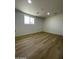 Bright bedroom featuring hardwood floors and a window allowing natural light to illuminate the space at 3807 N 64Th Dr, Phoenix, AZ 85033