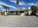 Charming single-story home with desert landscaping, wooden shutters, and a welcoming entrance at 3807 N 64Th Dr, Phoenix, AZ 85033