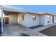 Single story grey home featuring an attached carport and manicured yard at 3821 W Verde Ln, Phoenix, AZ 85019