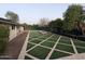Spacious backyard with artificial grass, a fire pit, and mature trees for added privacy at 4145 E Libby St, Phoenix, AZ 85032