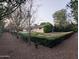 Backyard featuring privacy hedges and neutral ground cover, creating a serene outdoor space at 4145 E Libby St, Phoenix, AZ 85032