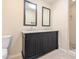 The bathroom features a dual sink vanity, tiled floors, and a shower with glass doors at 4145 E Libby St, Phoenix, AZ 85032