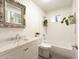 Bright bathroom with a vanity sink, shower over tub, and decorative mirror at 4145 E Libby St, Phoenix, AZ 85032