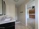 This bright bathroom features a dual sink vanity, tiled floors, and a walk-in shower at 4145 E Libby St, Phoenix, AZ 85032
