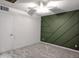 Clean bedroom with a dark green accent wall and new carpet at 4145 E Libby St, Phoenix, AZ 85032