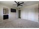 Spacious bedroom features plush carpet, ceiling fan, and access to a well-appointed ensuite bathroom at 4145 E Libby St, Phoenix, AZ 85032