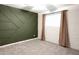 Spacious bedroom with a modern accent wall, new carpet, and natural light at 4145 E Libby St, Phoenix, AZ 85032