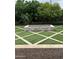 Close-up of an outdoor brick fire pit surrounded by artificial turf in a unique geometric pattern at 4145 E Libby St, Phoenix, AZ 85032