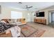 Comfortable living room featuring a large sectional, modern ceiling fan, and decor at 4145 E Libby St, Phoenix, AZ 85032