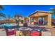 Inviting backyard with fire pit, seating, pool, and desert landscaping perfect for relaxing and entertaining at 4273 E Gleneagle Dr, Chandler, AZ 85249