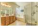 Bright bathroom featuring double vanity, soaking tub, and glass shower at 4273 E Gleneagle Dr, Chandler, AZ 85249