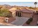 Expansive view of a desert home featuring a tile roof, three-car garage, and desert landscape at 4273 E Gleneagle Dr, Chandler, AZ 85249