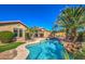 Lush backyard pool features rock waterfall, landscaping, and turquoise blue water for outdoor enjoyment at 4273 E Gleneagle Dr, Chandler, AZ 85249