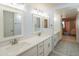Bright bathroom featuring dual sinks with quartz countertops, and stylish tile flooring at 4303 E Cactus Rd # 326, Phoenix, AZ 85032