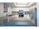 Well-lit kitchen with stainless steel appliances, granite counters, modern backsplash, and under cabinet lighting at 4303 E Cactus Rd # 326, Phoenix, AZ 85032