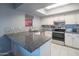 Updated kitchen with white cabinets, granite countertops, tile backsplash, and stainless steel appliances at 4303 E Cactus Rd # 326, Phoenix, AZ 85032
