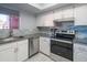 Updated kitchen featuring granite counters, tile backsplash, stainless steel appliances, and white cabinets at 4303 E Cactus Rd # 326, Phoenix, AZ 85032