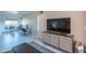 Living room with a modern television console with a view into the dining area at 4303 E Cactus Rd # 326, Phoenix, AZ 85032
