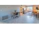 Bright living room featuring tile floors, a work space and a cozy seating area with balcony access at 4303 E Cactus Rd # 326, Phoenix, AZ 85032