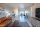 Bright living room with modern decor and a view into the dining area and ceramic tile flooring at 4303 E Cactus Rd # 326, Phoenix, AZ 85032