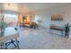 Bright living room featuring tile floors, a work space and a cozy seating area with balcony access at 4303 E Cactus Rd # 326, Phoenix, AZ 85032