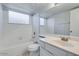 Well-lit bathroom featuring a tub with tile surround and a vanity with a neutral countertop and plenty of space at 4330 E Desert Trumpet Rd, Phoenix, AZ 85044