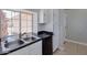 Kitchen with stainless steel sink, dark countertop, white cabinets, and view to the outside at 4330 E Desert Trumpet Rd, Phoenix, AZ 85044