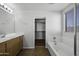 Bathroom featuring a tub, single sink vanity, and a large mirror at 4552 S 238Th Ln, Buckeye, AZ 85326