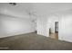 Large, open bedroom with neutral paint, ceiling fan, and open access to other rooms at 4552 S 238Th Ln, Buckeye, AZ 85326