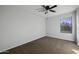 Cozy bedroom with ceiling fan and a window providing natural light and backyard view at 4552 S 238Th Ln, Buckeye, AZ 85326