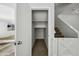 View of an open coat closet with a clothing rod near the carpeted staircase at 4552 S 238Th Ln, Buckeye, AZ 85326